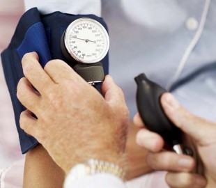 Pair of Human Hands Checking the Blood Pressure of a Patient