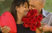 African American man giving Valentine's Day gifts to wife