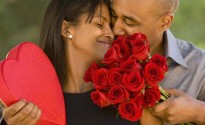 African American man giving Valentine's Day gifts to wife