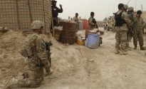 U.S. soldiers keep watch at the entrance of a U.S. base in Panjwai district Kandahar