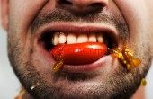 getty_rm_photo_of_man_biting_tomato