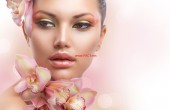 Beautiful Girl With Orchid Flowers. Perfect Make-up