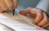 Man's Hands Signing Document