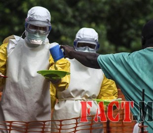 Medical staff working with Medecins sans Frontieres prepare to bring food to patients kept in an isolation area at the MSF Ebola treatment centre in Kailahun