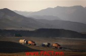 Coal trucks drive along a road leading to a mine located on the outskirts of the city of Baotou, in China's Inner Mongolia Autonomous Region