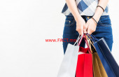 Smiling happy Asian woman shopping and holding bags